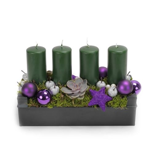 Christmas arrangement with four green candles